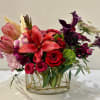 Blush and Bordeaux Tale is a stunning floral arrangement that blends the