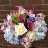 An assortment of soft hues. Hydrangea, double stock, freesia and roses makes