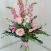 Pinks and whites arranged in a tall clear vase