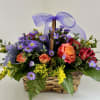 A gorgeous re-usable wicker basket filled with the seasons blooms! Filled with
