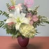Pink vase with pink and white flowers . Perfect for any occasion