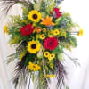 Yellows, oranges and reds round out this standing spray with a celebration
