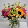 Make their day unforgettable with a radiant mix of sunflowers, pink roses