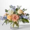 Inspired Bouquet artfully blends soft Peach Roses, Nory Roses, and delicate Blue