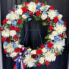 Standing tall in honor and remembrance, this wreath is meticulously crafted with