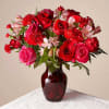 Hot pink roses, red roses, mini carnations &amp; more flowers make a