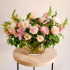 This fun garden-style arrangement displays a premium collection of pale pink and