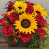 Stunning red roses and sunny sunflowers designed in a beautiful dark stained