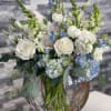 A breathtaking array of blue hydrangeas, soft white garden roses, light blue