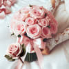 This package includes a beautiful fresh pink rose bridal bouquet and a