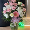 fresh pink and white flowers in large vase  with hello kitty