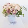 Soft blush roses, orchids in a chic vase. She's Called Celfie and