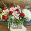 Upscale and modern arrangement of roses, hydrangea and orchids. 
Measures approx. 18"