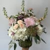 Seasonal whites, pinks and blush pinks arranged in a vase. 