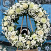 Seasonal White Flowers arranged into a wreath. 