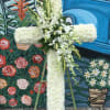 Seasonal white flowers arranged into a cross. (Wood stand included)

*(Order must be