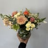 Seasonal pastel flowers arranged in a vase. 