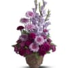 A towering display of blooms such as gladioli, carnations and chrysanthemums in