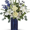 With its deep cobalt glass vase and pure white blooms, this soothing