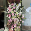 A beautiful standing spray with pink and white flowers.