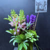 Purple liatrus, pink snap dragons, succulent, greenery elements.

We use flowers that are