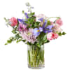 This enchanting spring floral arrangement is a harmonious blend of soft lavender