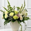 A luxurious all-white floral arrangement that exudes elegance and sophistication. Featuring a