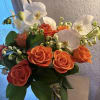 Elegant flower arrangement with orchids, roses and variety of flowers 