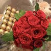 12 red roses bouquet, with green wrapped in a clear paper inside