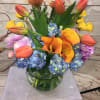 Celebrate the summery mood with this fun arrangement.Bright colorful tulips,roses,calla lilies mixed