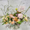 Modern and delicate floral arrangement in a beige ceramic vase. Very impressive
