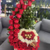 A stunning tall crescent-shaped arrangement designed with red and ivory roses, featuring