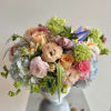 A lovely arrangement of spring flowers in pastel colors, in a beautiful