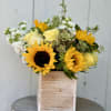 A really cute sunflower and yellow roses with white stock and a