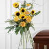 This warm and wonderful spray with its yellow sunflowers and gerberas seemingly