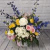 This large bouquet features striking iris, hydrangea, delphinium, pure white roses, adorable