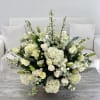 Arrangement of Hydrangeas, Roses, Lillies and Delphinium flowers in a golden vase