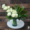 Contemporary statement piece includes one dozen premium white roses in an elegant
