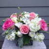 Beauty is overflowing in this pink and white arrangement. In a clear