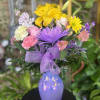 Fresh flowers in purple vase 