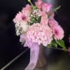 fresh pink flowers in pink long vase 