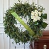 Seeded eucalyptus, Pavrifolia and white roses for a modern sympathy wreath. You