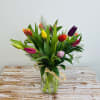 Send some springtime cheer with this delightful assortment of 15 Tulips accented