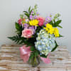 A lovely designer arrangement full of fresh blooms of Roses, Hydrangea, sweet