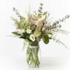 This delicate arrangement includes ranunculus, scabiosa, astrantia and lisianthus.
