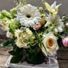 Spring themed arrangement of gerber daisy, stock, viburnum, iris and like seasonal