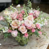 A collection of mixed soft pinks and white, filled with spray roses