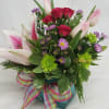 Lilies, tulips, mum, spray roses in cube. Some substitutions may be used