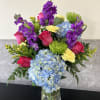 Purple stock, lime green fuji mums, hot pink roses, blue hydrangea, yellow