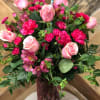 Strawberry Sunset includes light pink roses, hot pink carnations and hot pink
